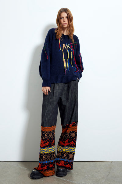 Pantalone in jeans a gamba larga con inserti in maglia