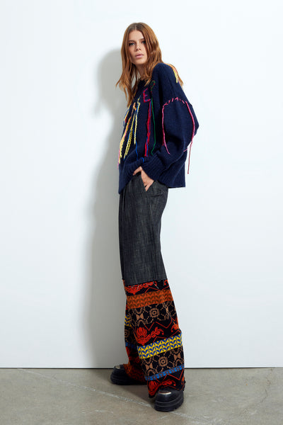 Pantalone in jeans a gamba larga con inserti in maglia
